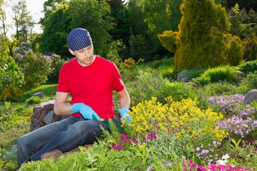 Landscape worker wearing PPE during outdoor maintenance work