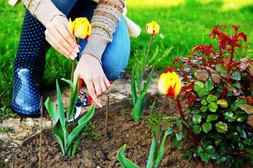 Workers using protective equipment during garden maintenance